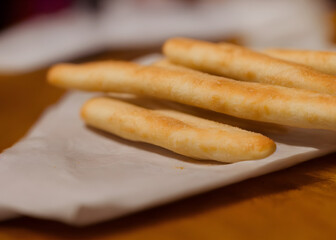 a photo of breadsticks, crusty baked food item, high calorie snack