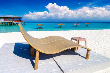 Fototapeta na wymiar Sun bed and parasol at tropical beach