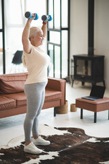 Cheerful female performing a strength training exercise indoors
