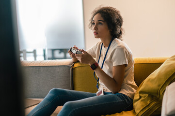 Young woman looking involved while playing play station