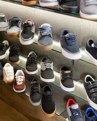 Assortment of male shoes on shelves in apparel boutique