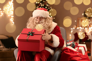 Fototapeta na wymiar Santa Claus opening gift box on Christmas eve