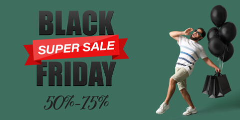 Handsome man with shopping bags and balloons on green background. Black Friday sale