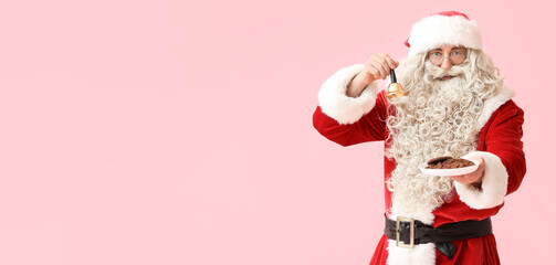 Santa Claus holding plate of cookies and Christmas bell on pink background with space for text