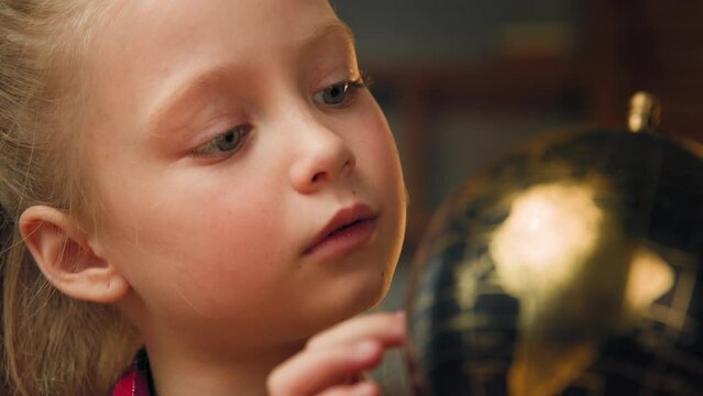 School girl pupil junior kid child traveler toddler look at globe search countries continents explore world study geography at home self-education spinning global map of planet cartography navigation