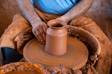 Hands of potter making a clay jug closeup. High quality photo