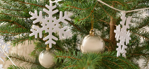 Beautiful Christmas tree decorated with snowflakes and balls, closeup