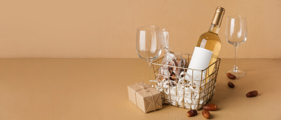 Gift basket with wine and sweet dates on color background with space for text