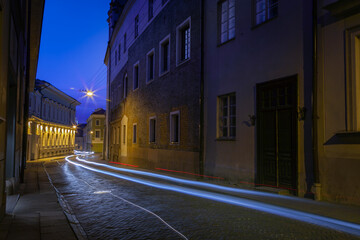 Street and luminous track from the car at night in Vilnius Old Town, Lithuania