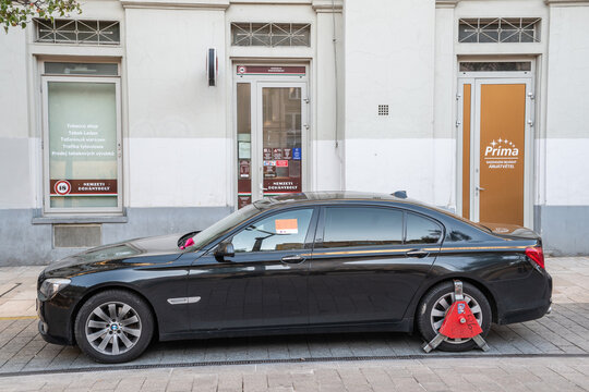 Budapest, Hungary – October 4, 2022. Car with a wheel clamp on a Budapest street.