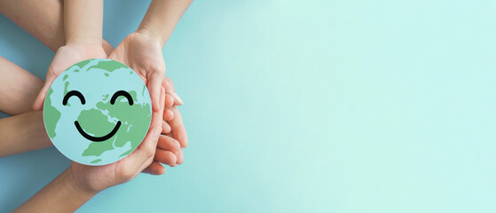 Hands holding earth with smile face, save planet, earth day, environment day, happy world, csr...