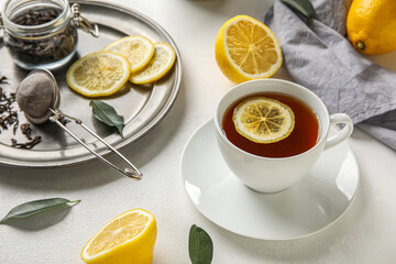 Cup of black tea with lemon on white table, closeup