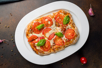 margarita pizza at the Rome dough top view on dark brown table