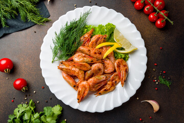 boiled shrimp on plate top view on dark table