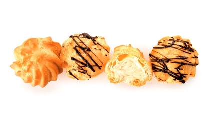 Tasty round eclairs with cream on white background