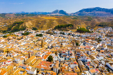 Scenic view from drone of center of Spanish city of Antequera overlooking ancient fortified Castle and Royal Collegiate church of San Sebastian, Andalusia, Spain - obrazy, fototapety, plakaty
