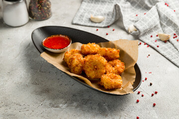 fried Cheese balls with sauce on grey table