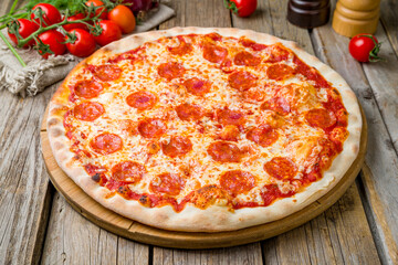 Pepperoni pizza on wooden table close up