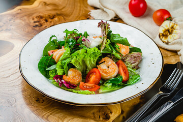 salad with vegetables and tiger prawns on wooden table