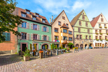 Fototapeta na wymiar Picturesque half timber buildings housing shops, cafes and homes in the historical town of Kaysersberg-Vignoble, France, in the Alsace region.