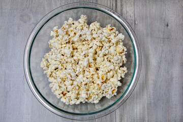 Top view of popcorn in a glass bowl.