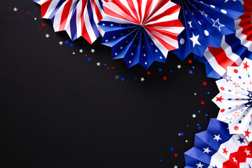 Decorations of red white and blue paper fans and confetti on black background. Veterans day,...