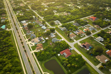 Aerial view of street traffic with driving cars in small town America suburban landscape with...