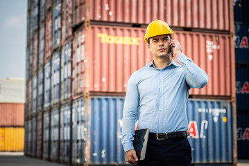 Caucasian worker use smartphone and tablet about business working at the port for transfer products.