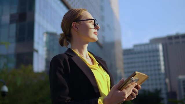 Young business woman in love looking at sunset happy face close-up. Grateful manager in formal suit with tablet looking up with eyes full of gratitude to God. Motivation and inspiration for success