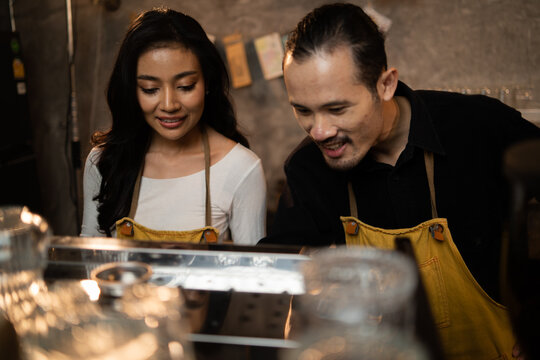 Barista Training Staff Using Coffee Matchine In Coffee Shop Cafe