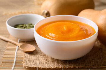 Butternut squash pumpkin soup in bowl, Homemade food in autumn season