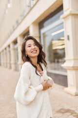 Glamour portrait attractive natural asian kazakh woman wearing white sweater Relaxing outdoor