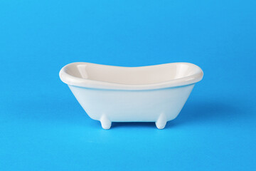 White wash tub on a blue background. Minimal concept.