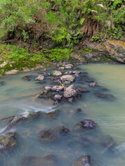 Naklejka na ściany i meble Water flowing between rocks in the creek.