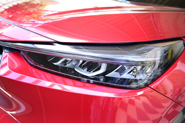 headlight of red car, transportation industry