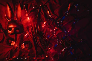 Handschellen, Lederpeitsche, Maske und Halsband für BDSM-Sex mit Unterwerfung und Dominanz. Konzept erotischer Sexspielzeuge für Erwachsene © alexkoral