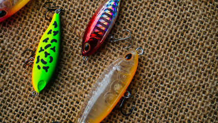 Artificial lure made from plastic for fishing by casting. Casting lure with hook on the burlap....