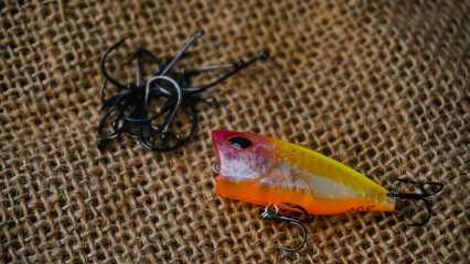 Artificial lure made from plastic for fishing by casting. Casting lure with hook on the burlap - Artificial lure with the shape of minnow
