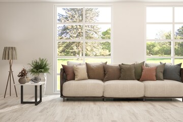 Fototapeta premium White living room with sofa and summer landscape in window. Scandinavian interior design. 3D illustration