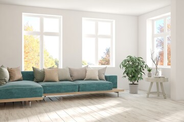 Stylish room in white color with blue sofa and autumn landscape in window. Scandinavian interior design. 3D illustration