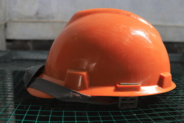 orange safety helmet hard hat, tool protect worker of danger in construction industry.