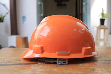 orange safety helmet hard hat, tool protect worker of danger in construction industry.