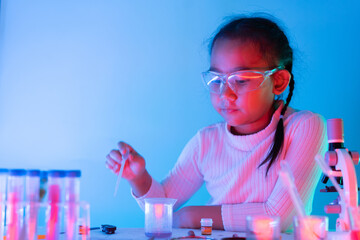 Asian girl with science experiment working education concept, With blue light and red