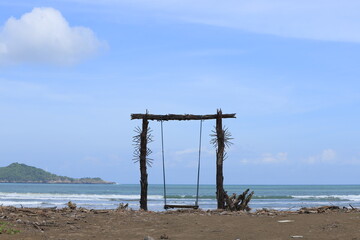 A wooden swing on the shores of Teleng Ria Beach in Pacitan, East Java. Great for nature backgrounds and wallpapers.