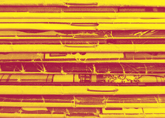 Stack of old vintage comic books creates colorful background texture with red yellow duotone effect