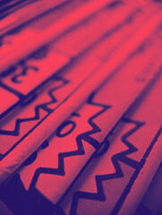 Old comic books stacked in a pile creates colorful background with abstract shapes and red blue...