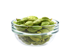 green cardamom seeds in a clear glass bowl isolated on white background.