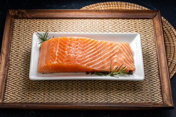 Fresh Salmon fish fillet, Natural Atlantic Norwegian Salmon Fillet Texture on white plate ready to cook or sashimi dish.