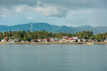 Fototapeta na wymiar Late afternoon by the coast and beach of Bato, Leyte with mountains at the background.