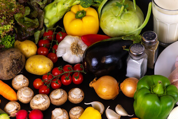 vegetables and diet food on a black background, top view, flatley